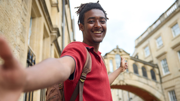 Young man travelling on vacation taking selfie sightseeing in Oxford