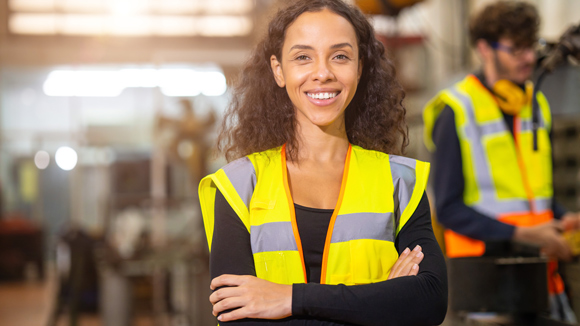 portrait African American black woman worker happy smile work in heavy metal machine industry